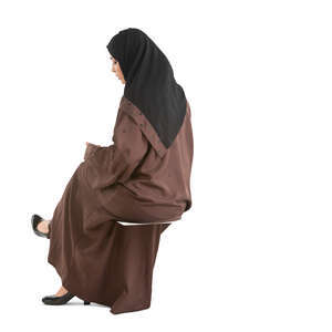 cut out muslim woman in a brown abaya sitting