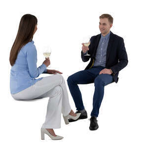 cut out man and woman sitting in a restaurant and drinking wine