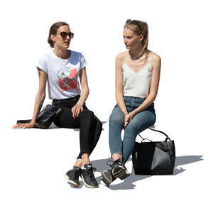 two cut out women sitting outside and talking