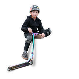 cut out little boy with a scooter sitting in the skatepark