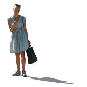 cut out backlit woman in a pale blue summer dress standing