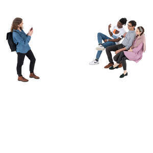 woman taking a picture of her three friends sitting on the bench