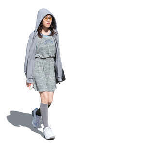 cut out asian woman in  grey dress and hoodie walking