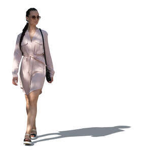 cut out woman in a pink summer dress walking in tree shade