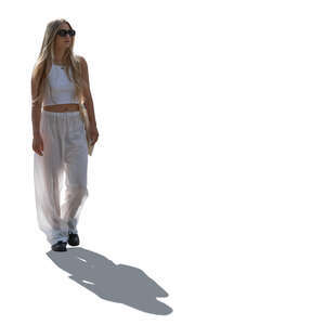 cut out backlit woman in white summer trousers walking