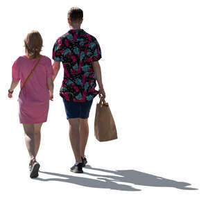 cut out backlit man and woman walking hand in hand