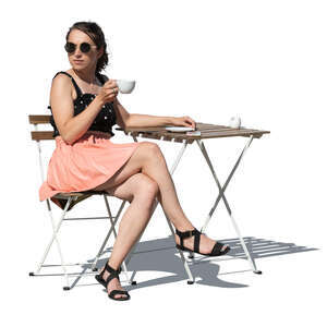 cut out woman sitting at a cafe table and drinking coffee