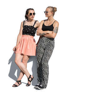 two cut out young women standing and leaning on a table edge