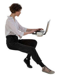 cut out woman sitting at a table with a laptop and drinking coffee