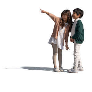 two cut out happy asian kids standing and pointing at smth