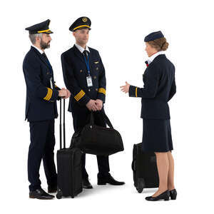 two cut out pilots and a female flight attendant with travelling bags standing and talking