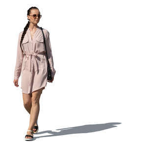 cut out woman in a pink shirt dress walking