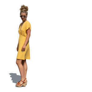 cut out woman in a yellow summer dress standing