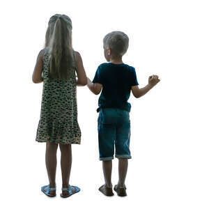 two cut out children standing at the window