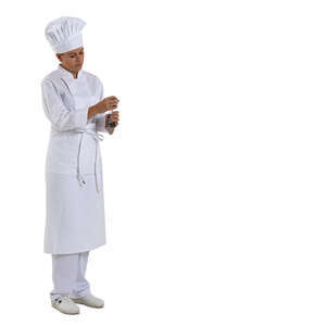 cut out restaurant chef standing in the kitchen and grinding pepper