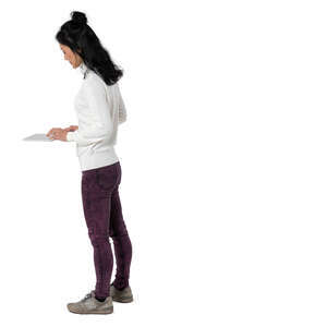 cut out woman standing at a counter and looking at a tablet