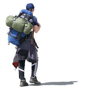 man with a hiking backpack walking in the sunlight