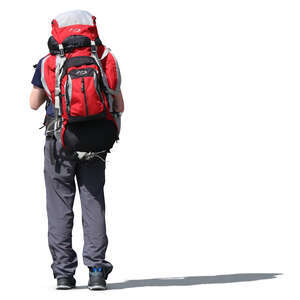 man with a big backpack standing in the sunlight