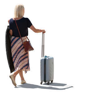 backlit woman woth a suitcase standing