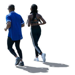 backlit man and woman jogging