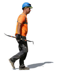 worker with a helmet walking with a crowbar in his hand