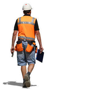 constrution manager with a helmet walking in the sunlight