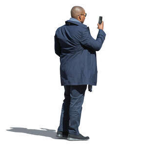 black man standing and taking a picture with his phone