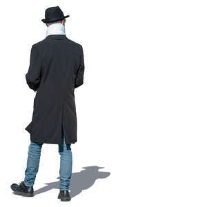 man with a black hat and overcoat walking