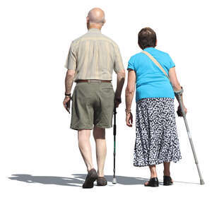 elderly man and woman walking with walking sticks