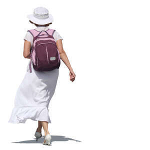 woman in a white dress carrying a backpack walking