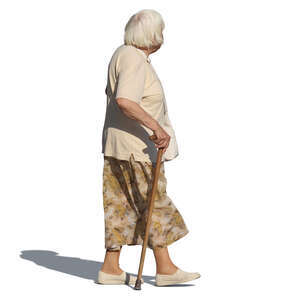 elderly woman with a walking stick walking on a summer day