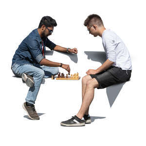 two cut out men playing chess outside on a bench