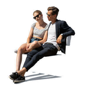 cut out couple sitting on a bench outside in the sun