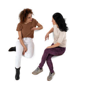 two cut out women sitting and talking seen from above