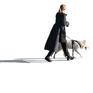 cut out woman in a black long coat walking a dog