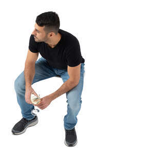 top view of a man sitting and drinking wine