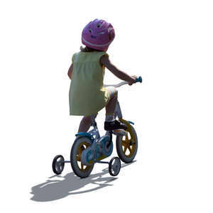 cut out backlit little girl riding a bike