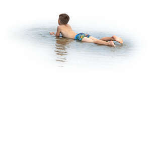 cut out boy lying in the water on the beach