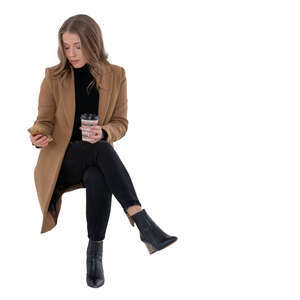 cut out woman in a brown overcoat sitting and drinking coffee