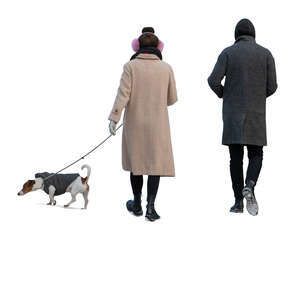 two cut out people walking a dog in winter