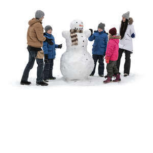 cut out kids and adults building snowman in winter