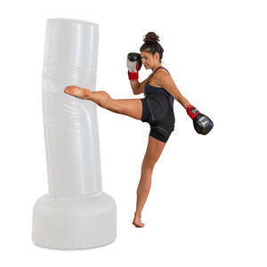 cut out woman at boxing class kicking a punching bag