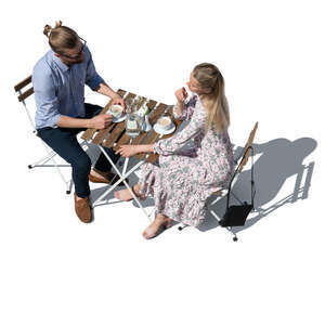 cut out top view of a man and woman sitting in an outdoor restaurant