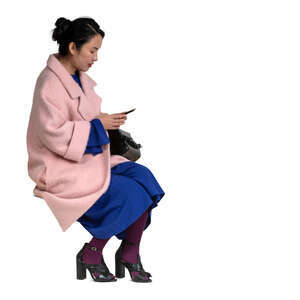 cut out woman in a pink overcoat sitting