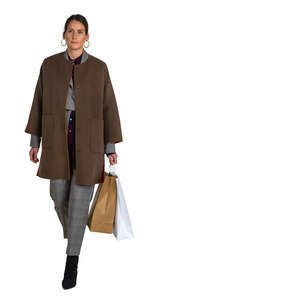 cut out woman in a brown overcoat carrying shopping bags walking