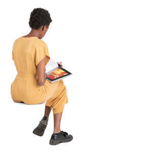 cut out woman in a yellow jumpsuit sitting and reading a magazine