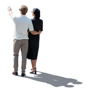 cut out backlit couple standing and pointing