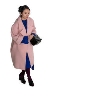 cut out asian woman in a pink overcoat walking seen from above