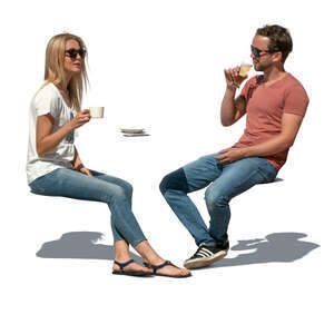 two cut out people sitting in an outdoor cafe on a sunny day