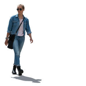 cut out backlit woman in denim outfit walking